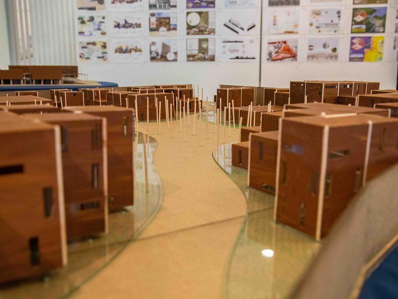 architectural models on a table in a classroom